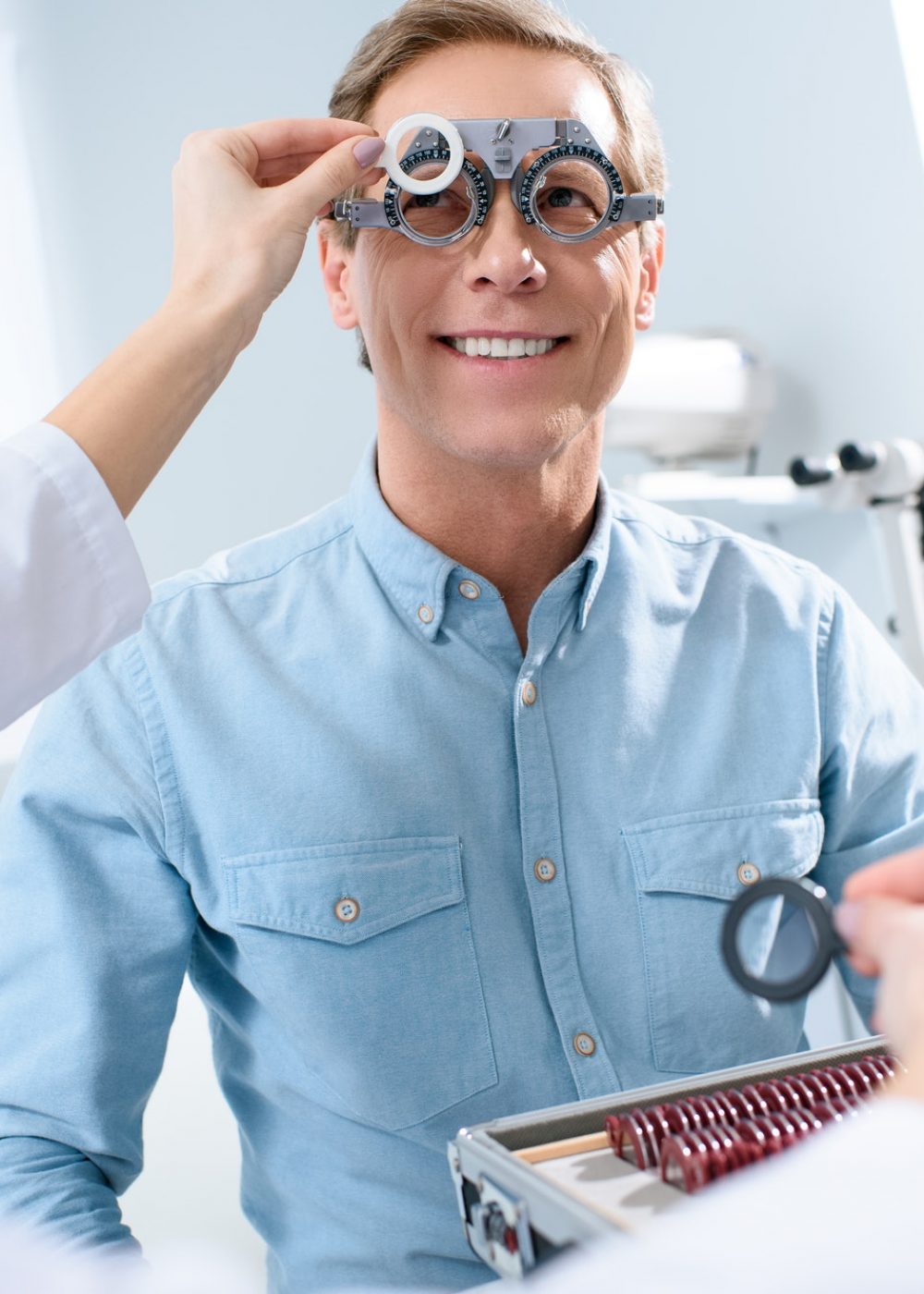 ophthalmologist-examining-middle-aged-man-eyes-with-trial-frame-and-lenses.jpg